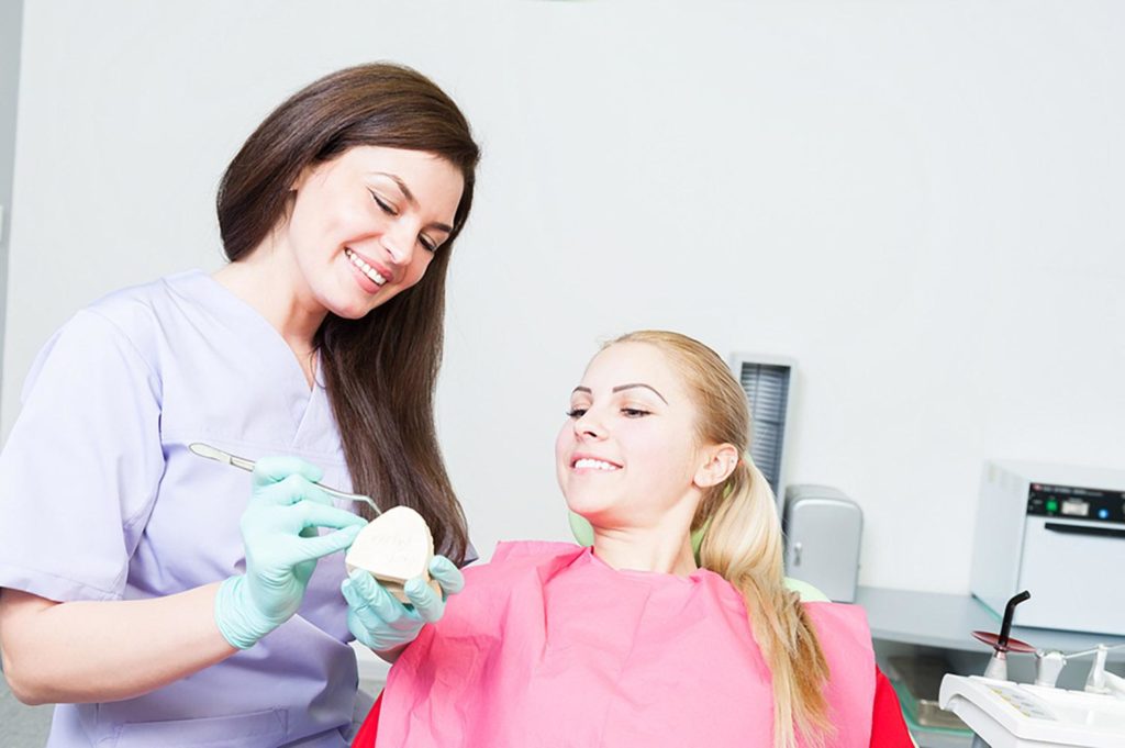 Beautiful Dentist Woman Showing Ceramic Prothesis Crown Bright Value